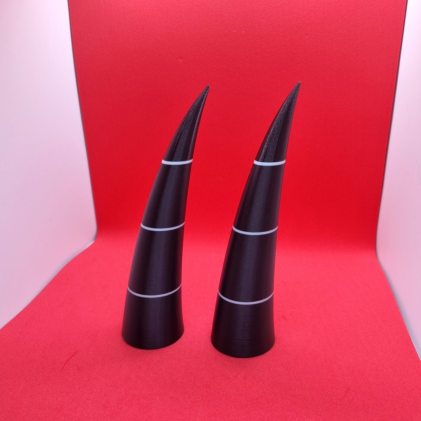 Pair of imp horns (black with white lines)