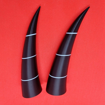 Pair of imp horns (black with white lines)