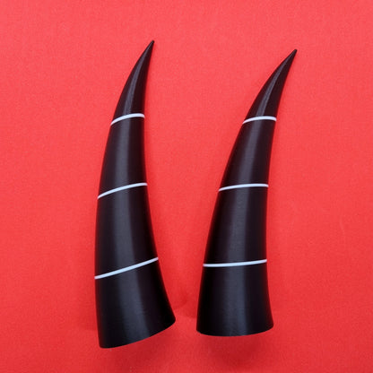 Pair of imp horns (black with white lines)