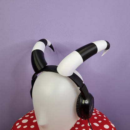 Helluva boss Fizzarolli imp horns for cosplay or halloween, they are black and white, and they can be attached to headphones as a headset accessory